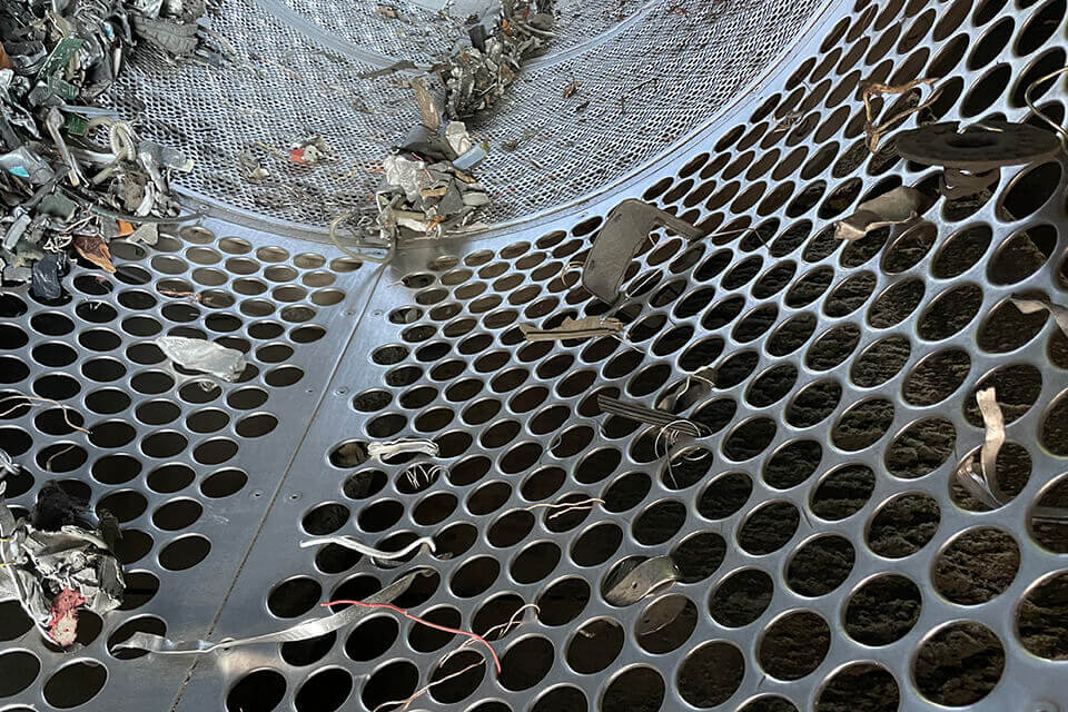 Detailblick in ein Trommelsieb. Man erkennt, dass Langteile sehr leicht durch den Siebbelag fallen können. Das ist schlecht für die Sortierqualität.