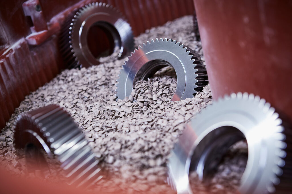 Gears in a vibratory finishing machine for surface finishing