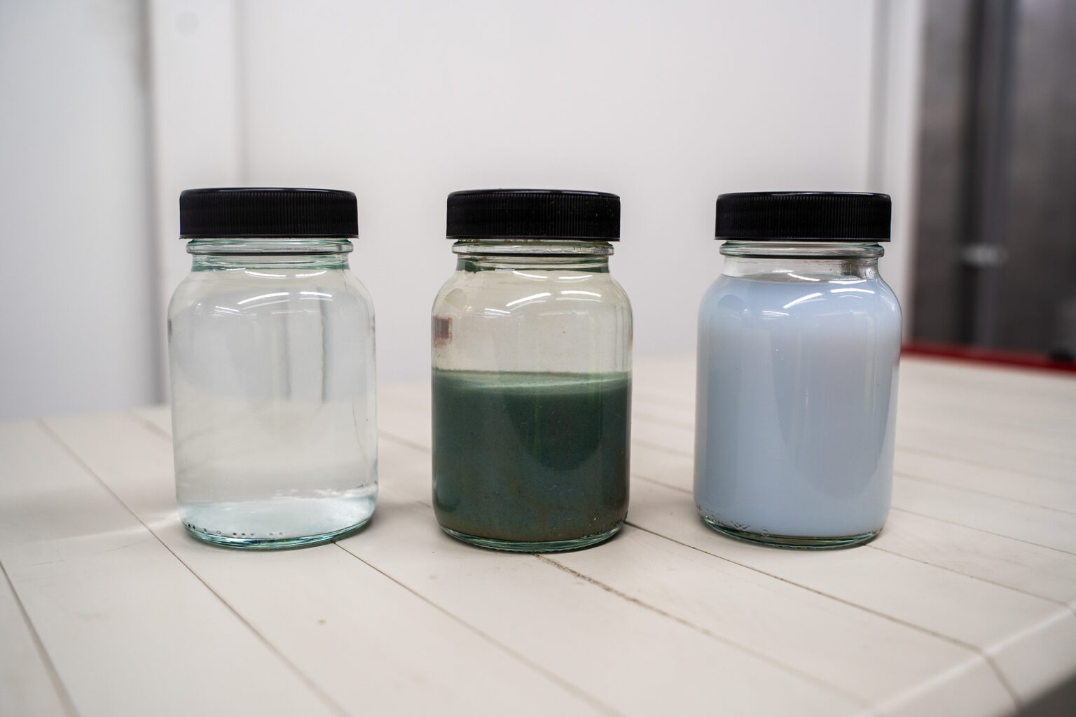 Three wastewater samples at different stages following treatment by electrocoagulation