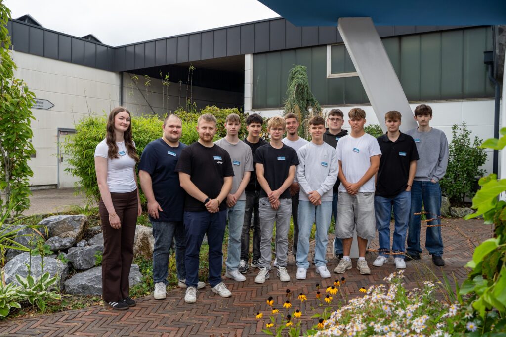A group of young apprentices in front of the entrance to Spaleck in Bocholt