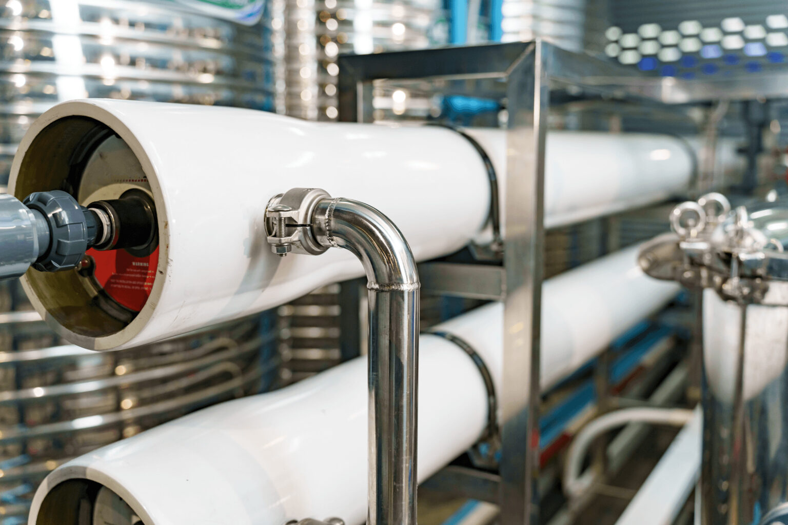 Close-up of a white pipe at an industrial water treatment plant
